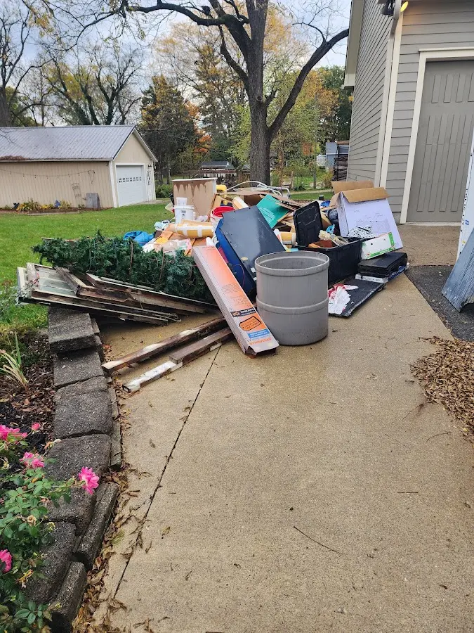 Dumpster being loaded with debris for Estate Cleanout Dumpster Rental in Orchard Homes